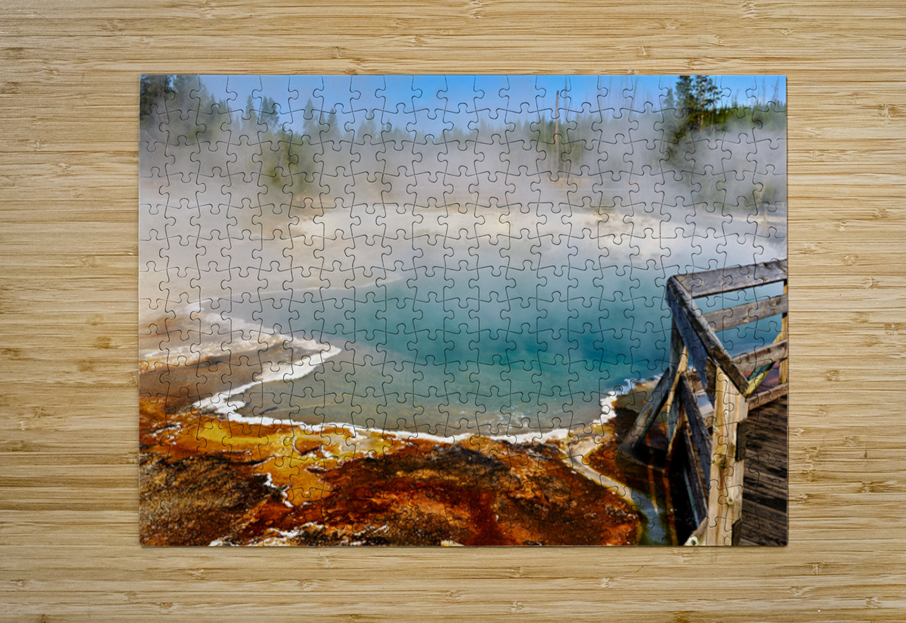 Steam rises from Abyss Pool as blue water reflects the surrounding landscape at Yellowstone National Park. Visitors explore the area nearby. Marco Brivio Puzzle printing
