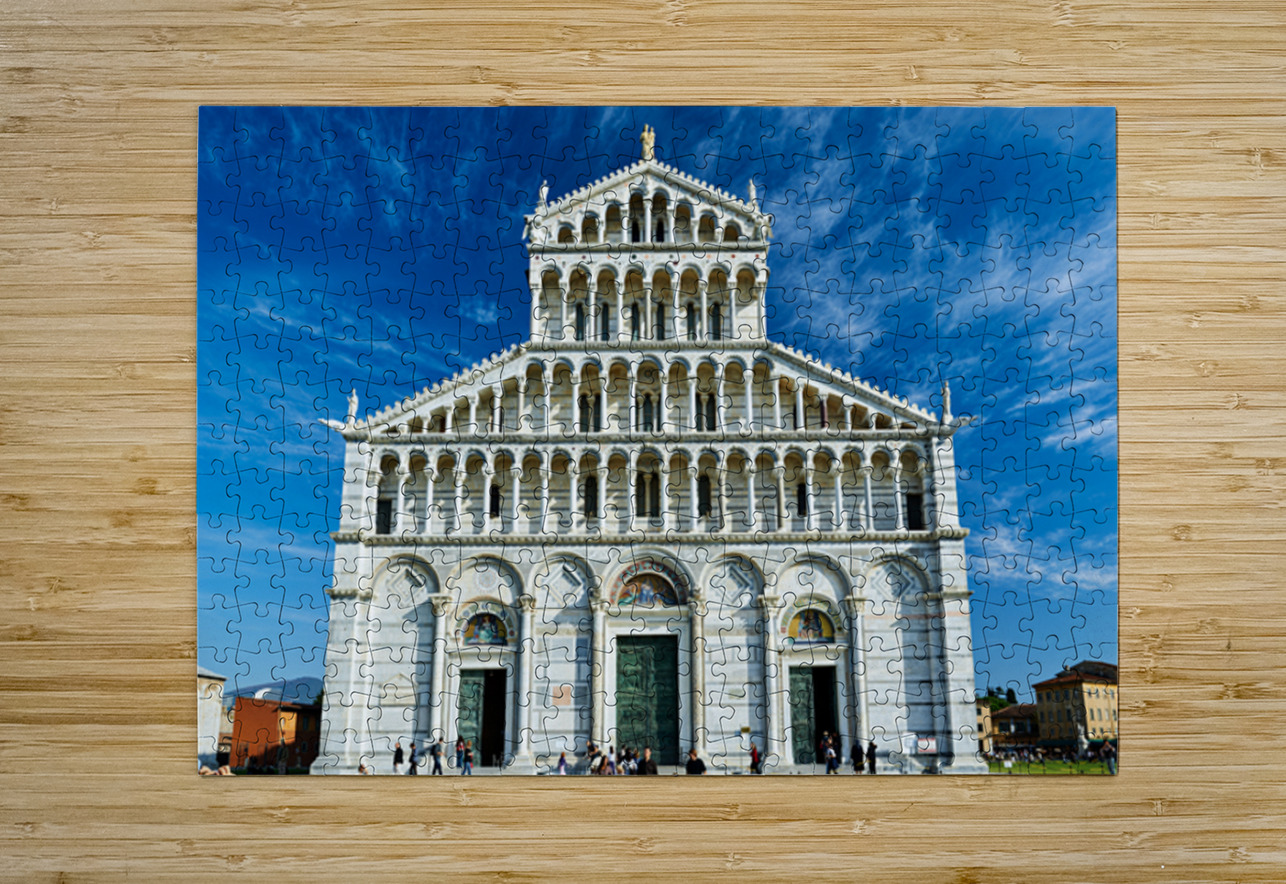 Visitors walk around Pisa Cathedral in Piazza dei Miracoli. The tall structure stands under a blue sky. People enjoy the lively atmosphere. Marco Brivio Puzzle printing