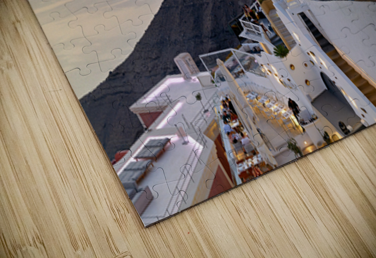 Santorini cliffside town with restaurants and people enjoying th Marco Brivio Puzzle