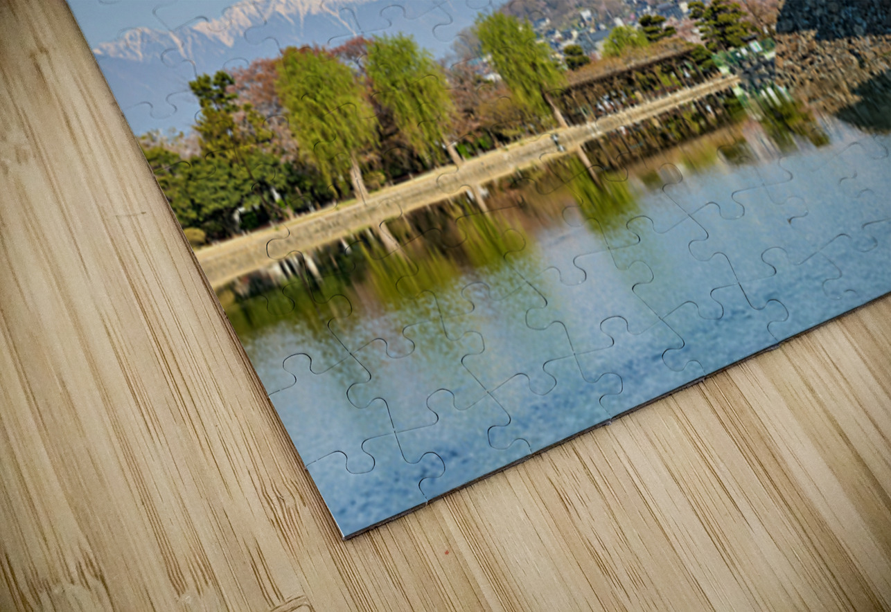 Matsumoto Castle stands beside water with mountains in the dista Marco Brivio Puzzle