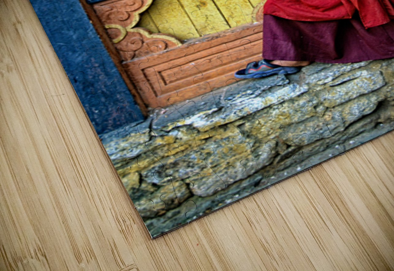 Smiling young monk in red robes at colorful traditional building Marco Brivio Puzzle