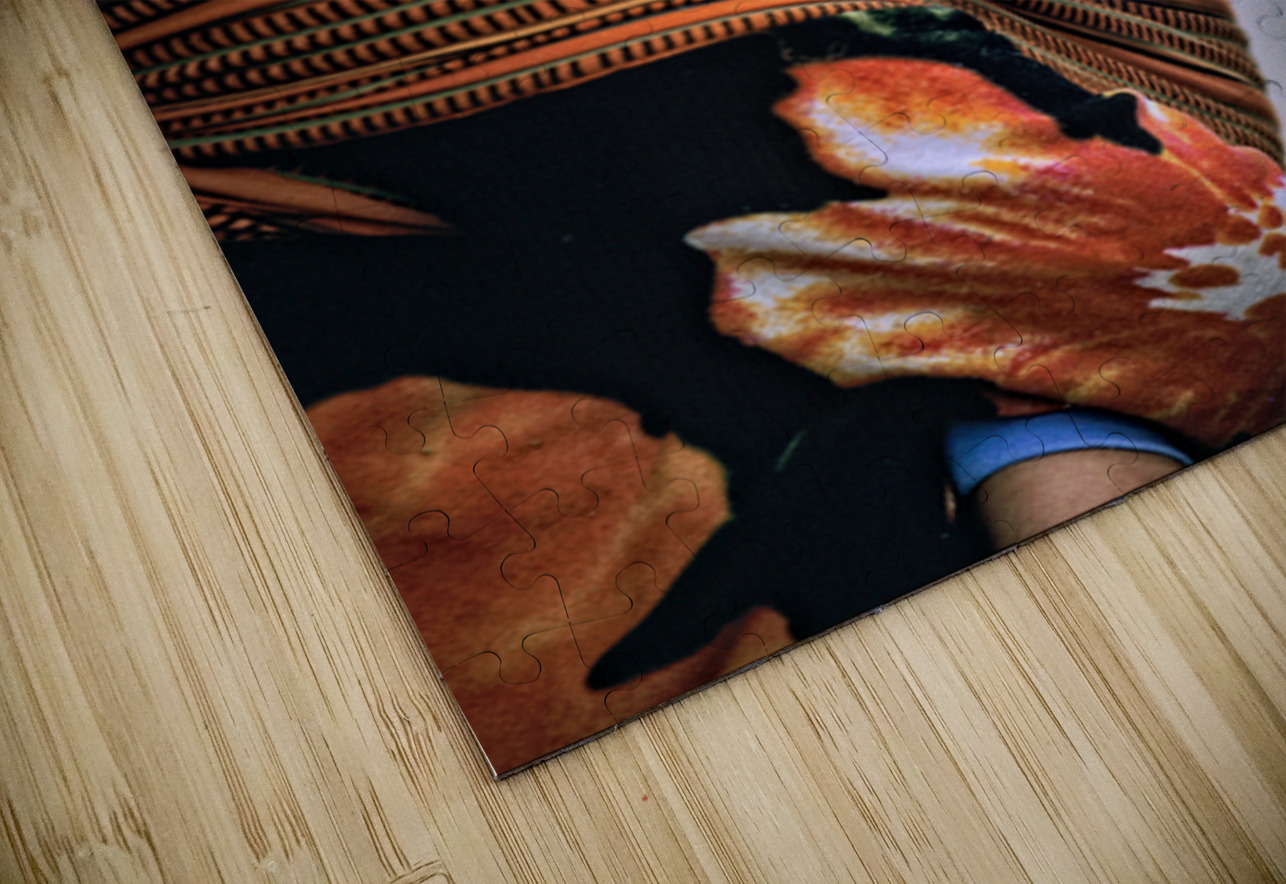 Curious child carried in a patterned fabric sling. Marco Brivio Puzzle