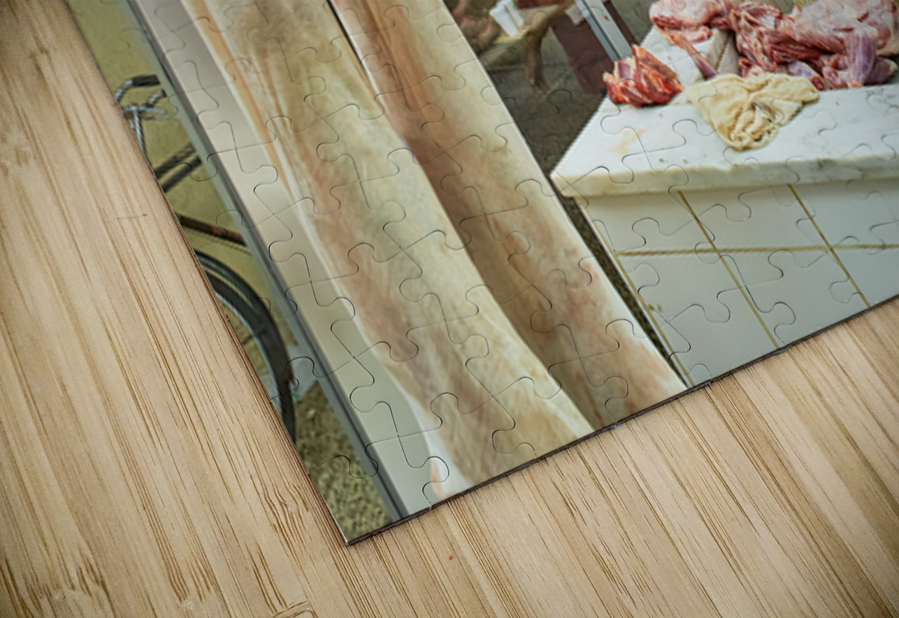 Butcher works in meat market in Dubai with hanging meat Marco Brivio Puzzle