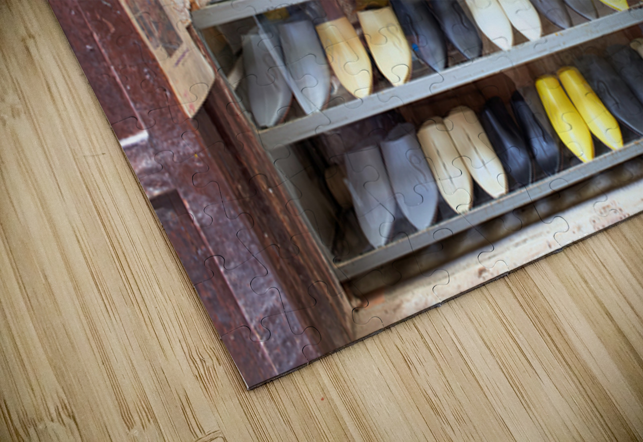 Moroccan babouches shoes in a Fez shop with a vendor Marco Brivio Puzzle