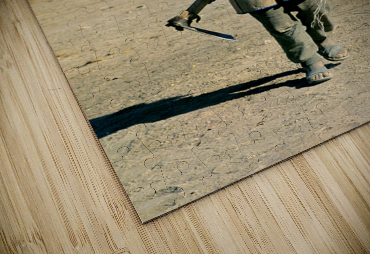 Indigenous boy with tools walks through a dusty village. Marco Brivio Puzzle