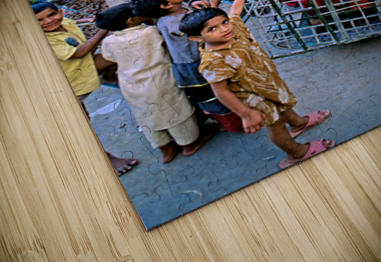 Children enjoy playtime on a swing in Lahore Marco Brivio Puzzle