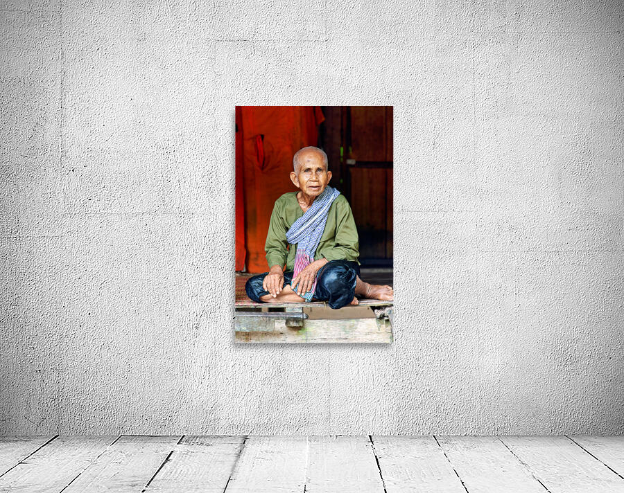 Elderly person in traditional clothing sitting calmly. Wall Preview