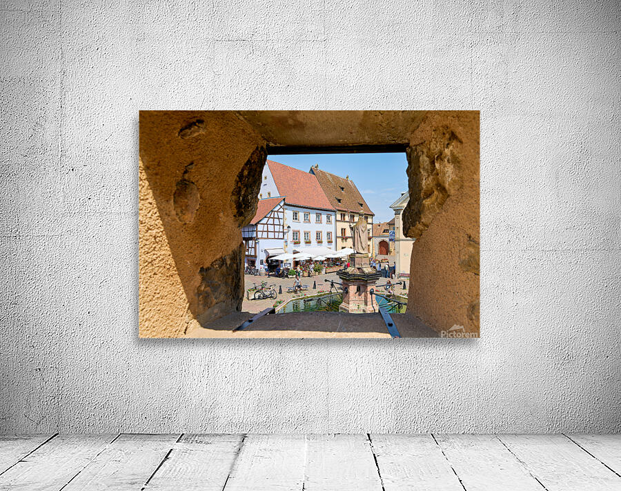 Visitors enjoy Saint Leon square in Eguisheim Alsace on wine rou Wall Preview