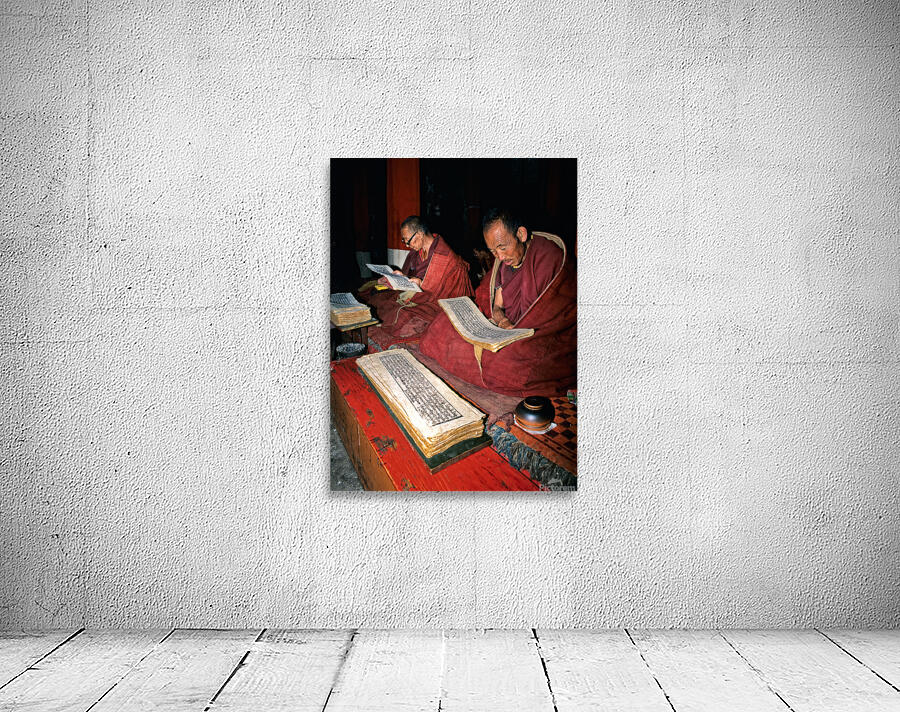 Monks read sacred texts in a Tibetan temple at night Wall Preview