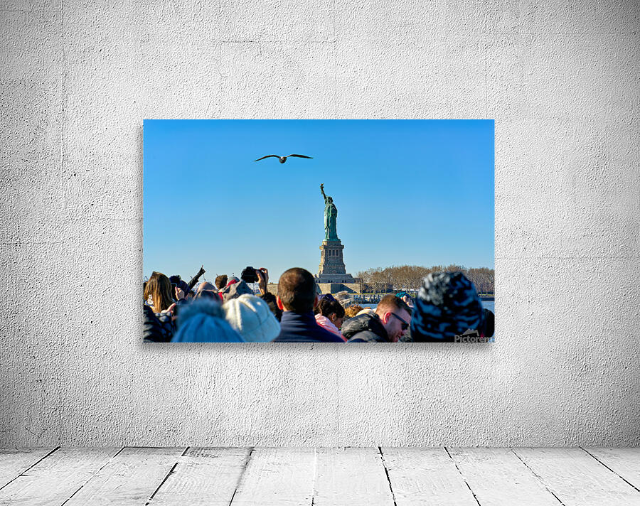 Tourists travel to Liberty Island by ferry in Manhattan New Yor Wall Preview