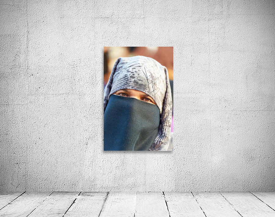 Veiled Moroccan woman in Marrakesh market on a sunny day Wall Preview
