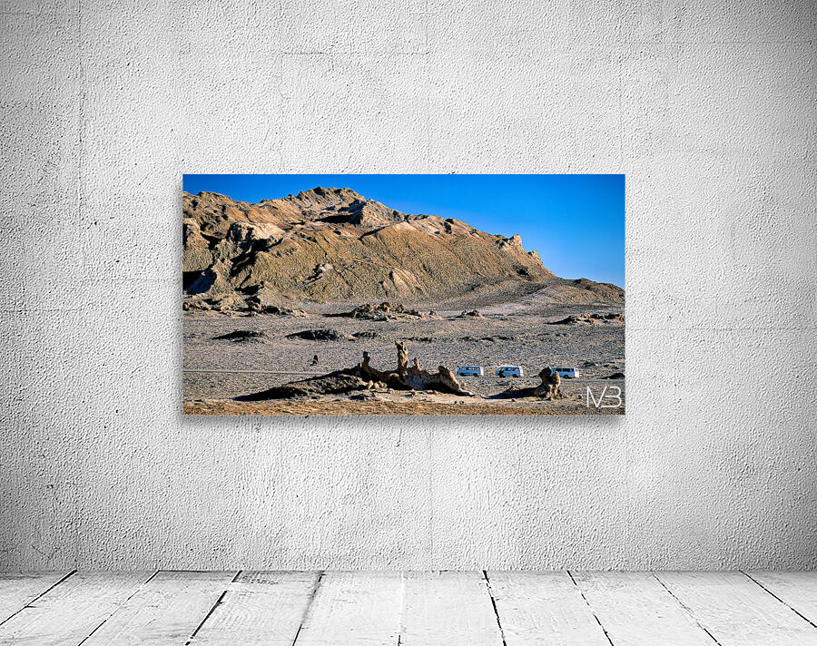 Arid mountain landscape with vans on a desert road. Wall Preview