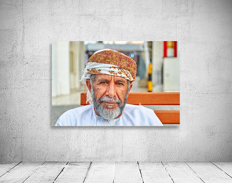 Man sitting on a bench in Muscat Oman during the day Wall Preview