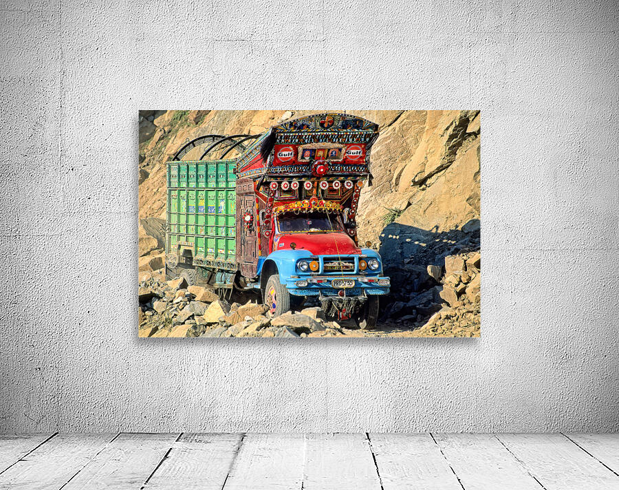 Trucks travel toward Shandur Pass in Pakistans rugged terrain Wall Preview