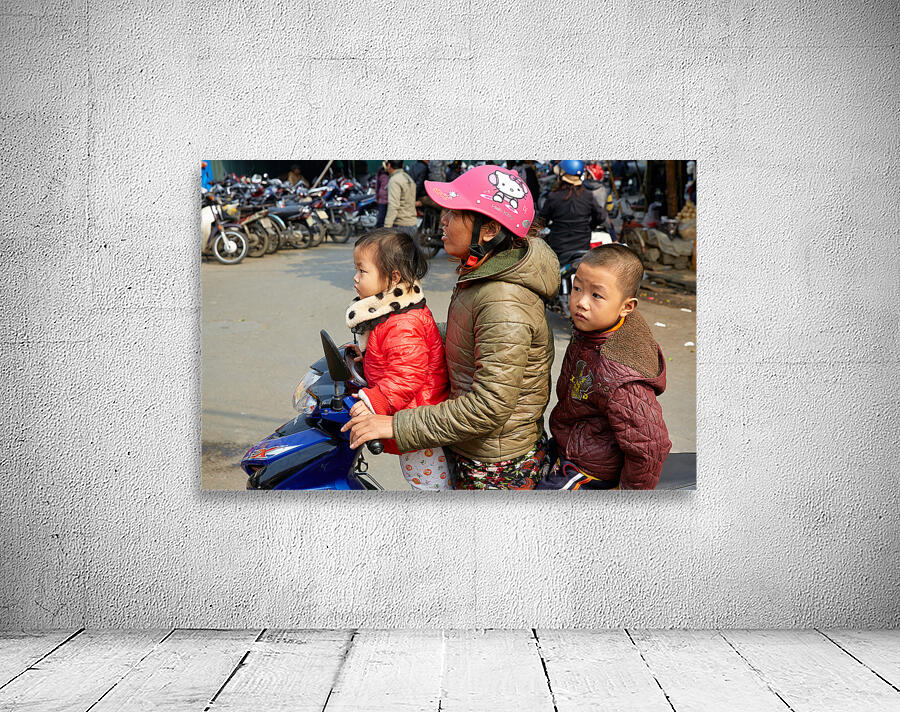 Children riding a motorbike in Hanoi streets Wall Preview