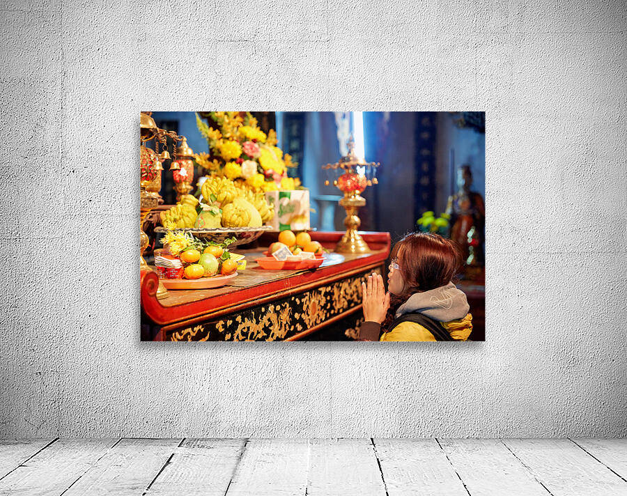 Person offers prayers at altar with fruits in Ho Chi Minh Wall Preview