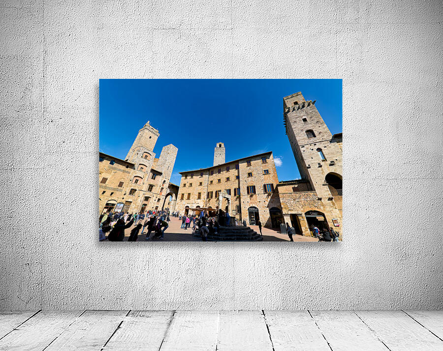 Visitors walk through Piazza della Cisterna in San Gimignano Wall Preview