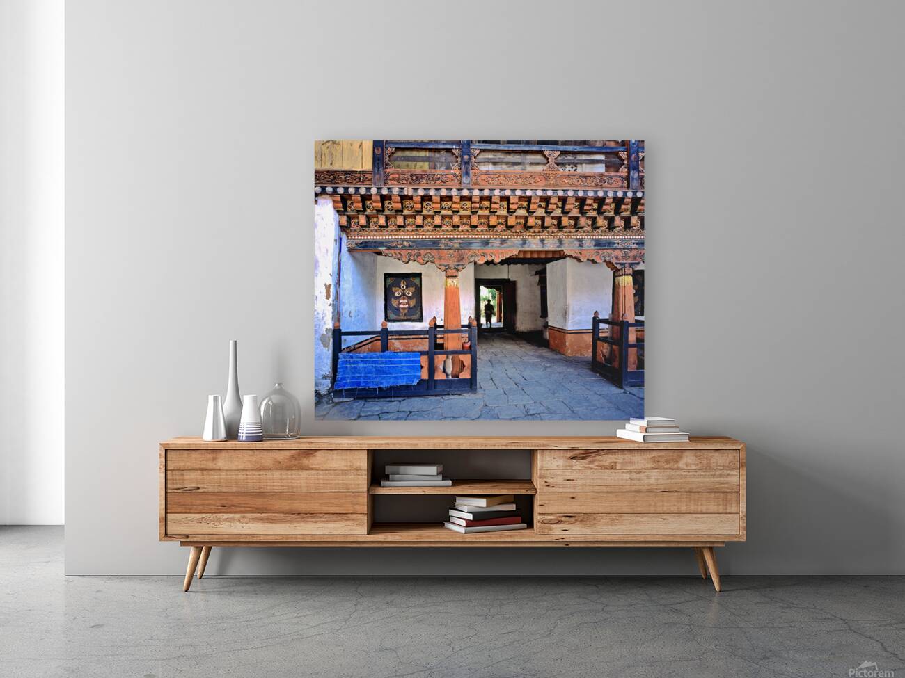 Intricate Bhutanese temple entrance with a person and fierce mas Reproduction