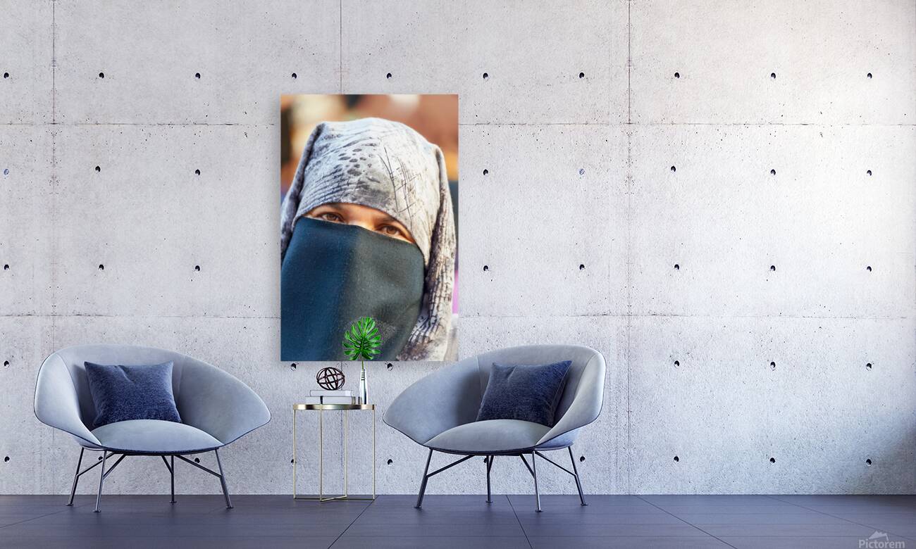 Veiled Moroccan woman in Marrakesh market on a sunny day Reproduction