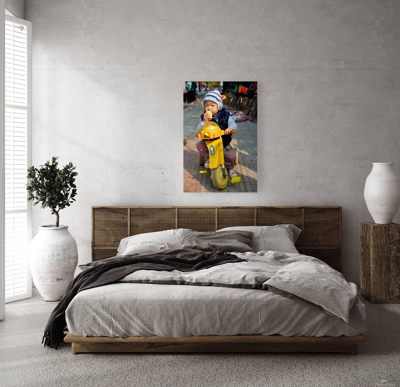 Child enjoys snack while riding tricycle in Hanoi streets Reproduction