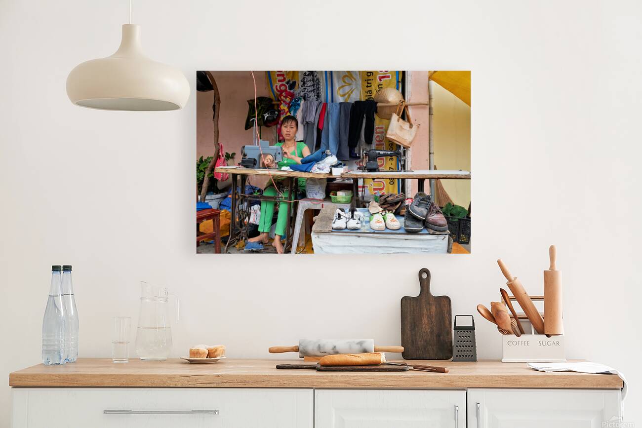 Sewing clothes at a market stall in Phu Quoc Vietnam Reproduction