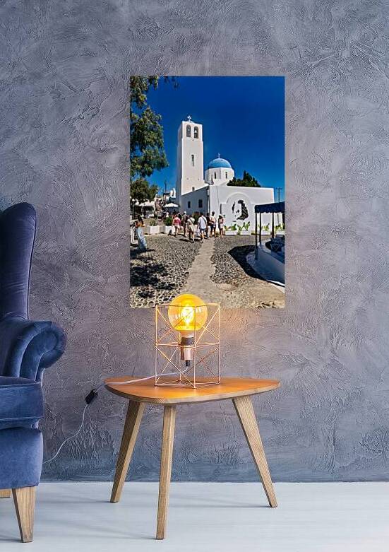 Greek village street with white church blue dome and tourists. by Marco Brivio