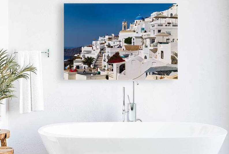 Santorinis iconic white buildings blue domes and caldera view by Marco Brivio