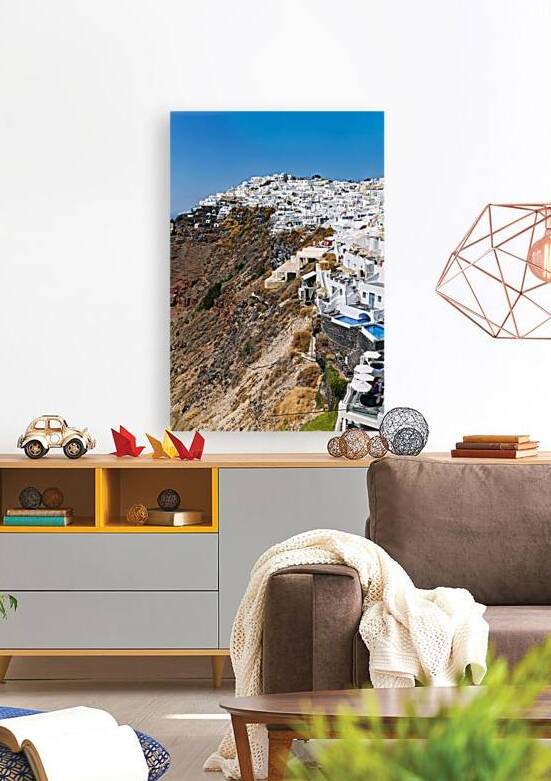 Whitewashed buildings cascade down Santorinis volcanic cliffsid by Marco Brivio