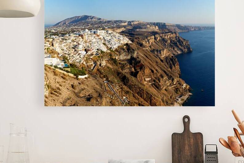 Santorinis white buildings on caldera cliffs above the sea. by Marco Brivio