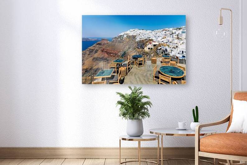 Santorini cafe terrace overlooking caldera and white village. by Marco Brivio