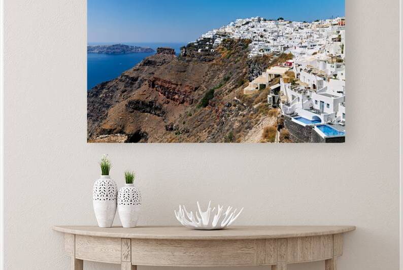 Santorini village on cliff overlooking caldera and sea. by Marco Brivio