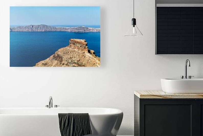 Santorinis volcanic caldera deep blue sea and distant island. by Marco Brivio