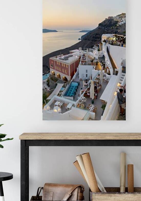 Santorini cliffside town with restaurants and sea view at sunset by Marco Brivio