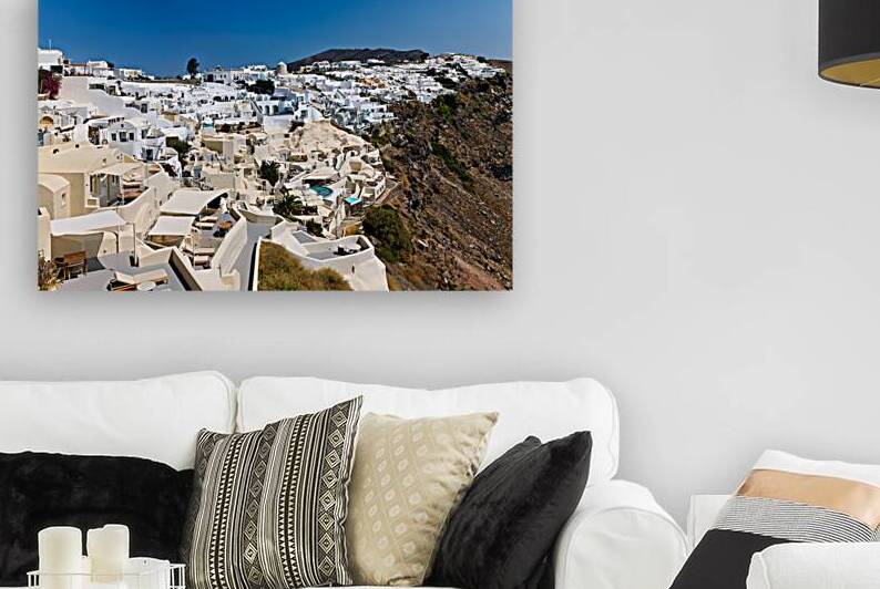 Panoramic view of white cliffside village in Santorini Greece. by Marco Brivio