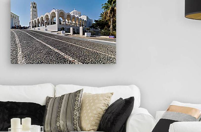 Beautiful white church and cobblestone street in sunny Santorini by Marco Brivio