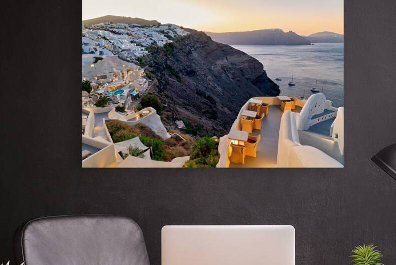 Sunset over Santorinis white village and caldera. by Marco Brivio