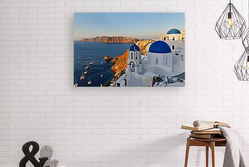 Santorinis beautiful blue domed churches caldera and sea. by Marco Brivio