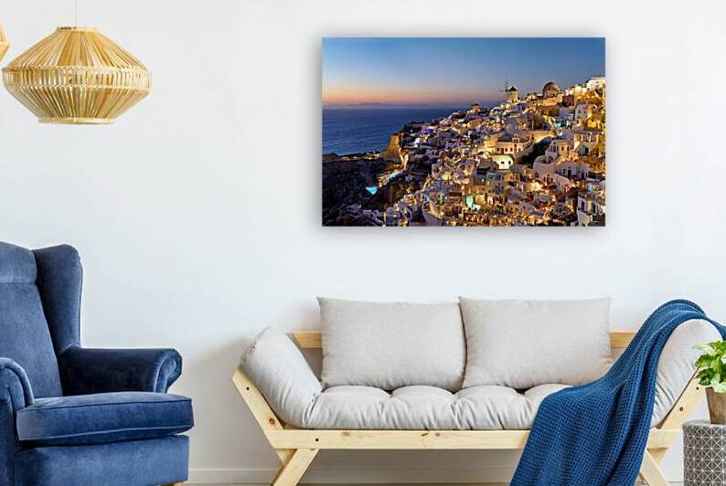 Santorinis Oia village illuminated at dusk overlooking the se by Marco Brivio