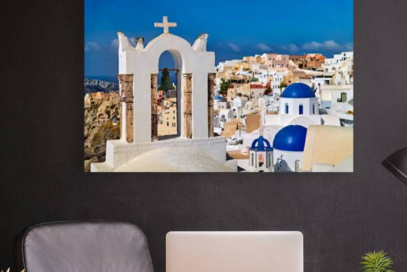 Santorinis iconic bell tower white houses blue domes caldera by Marco Brivio