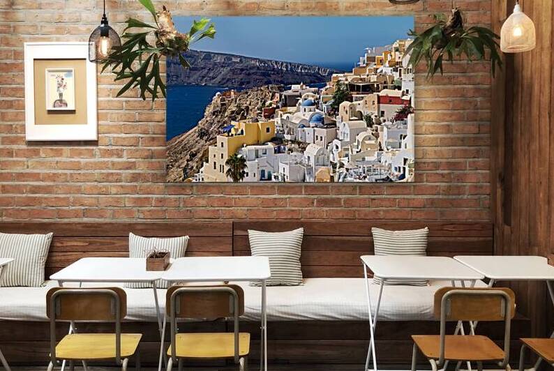 Picturesque Santorini village on cliff overlooking Aegean Sea. by Marco Brivio