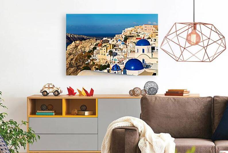 Santorinis iconic white buildings and blue domes overlooking th by Marco Brivio
