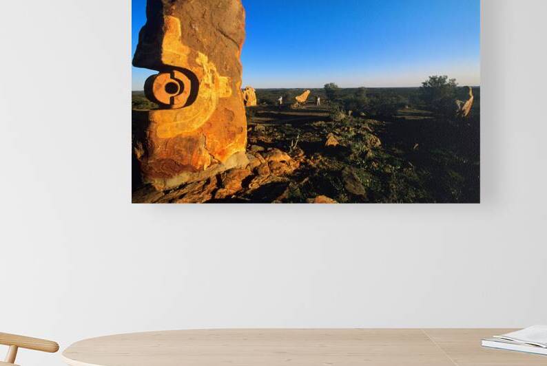 Sandstone sculptures glow at sunset in the Australian outback. by Marco Brivio