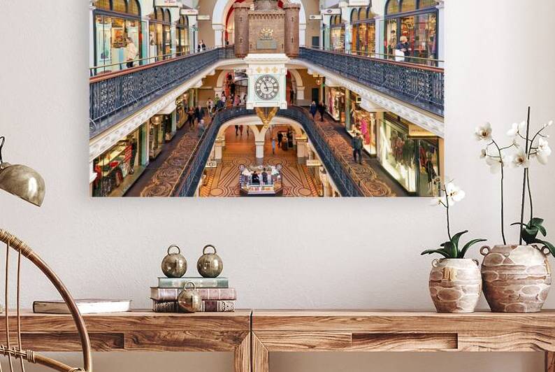 Elegant Victorian shopping arcade with clock tower and shoppers. by Marco Brivio