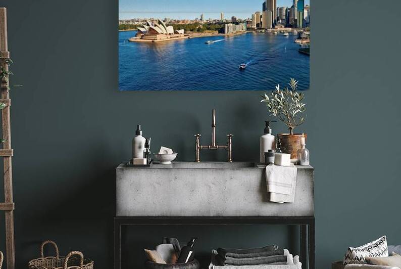 Sydney Opera House and city skyline with boats on water. by Marco Brivio