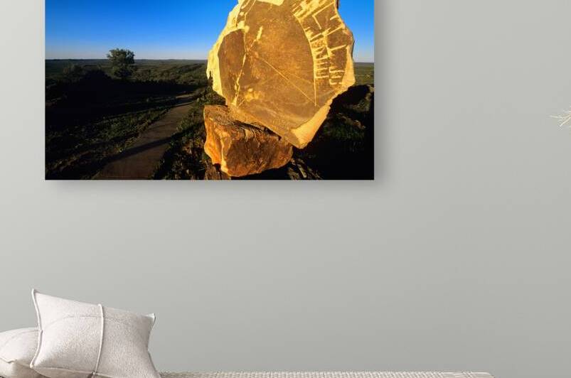 Carved stone monument in the Australian outback at sunset. by Marco Brivio
