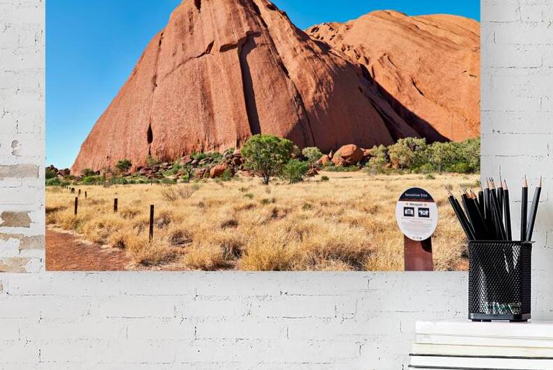 Uluru Australia a sacred monolith under a clear blue sky. by Marco Brivio