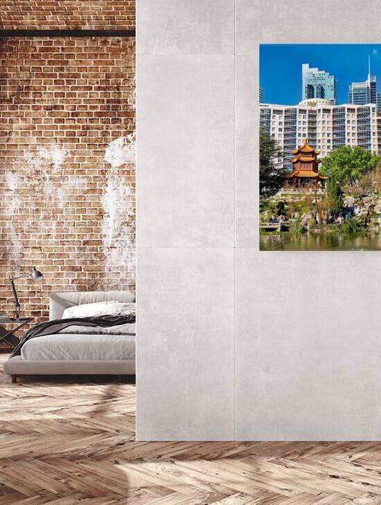 Traditional Chinese garden with modern skyscrapers in background by Marco Brivio