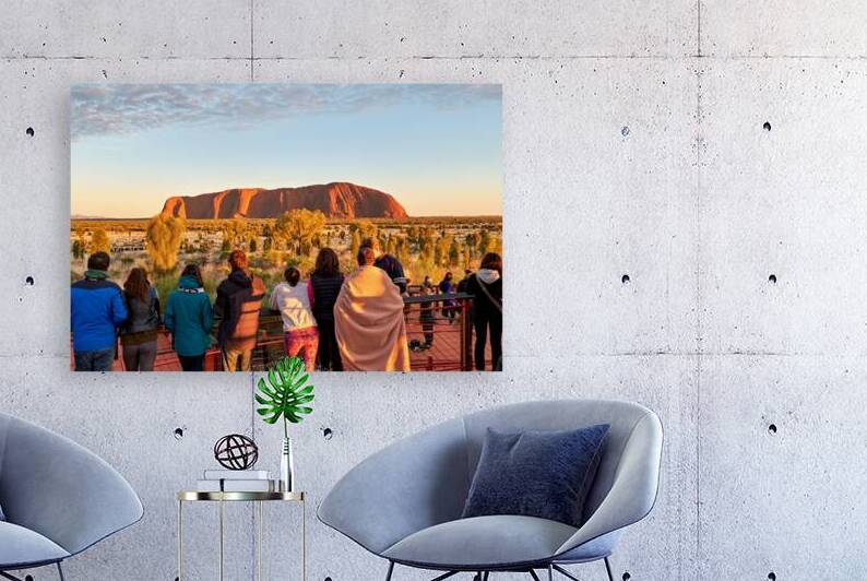 Tourists watch Uluru glow at sunrise. by Marco Brivio