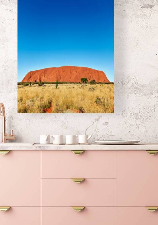 Uluru monolith under a clear blue sky. by Marco Brivio