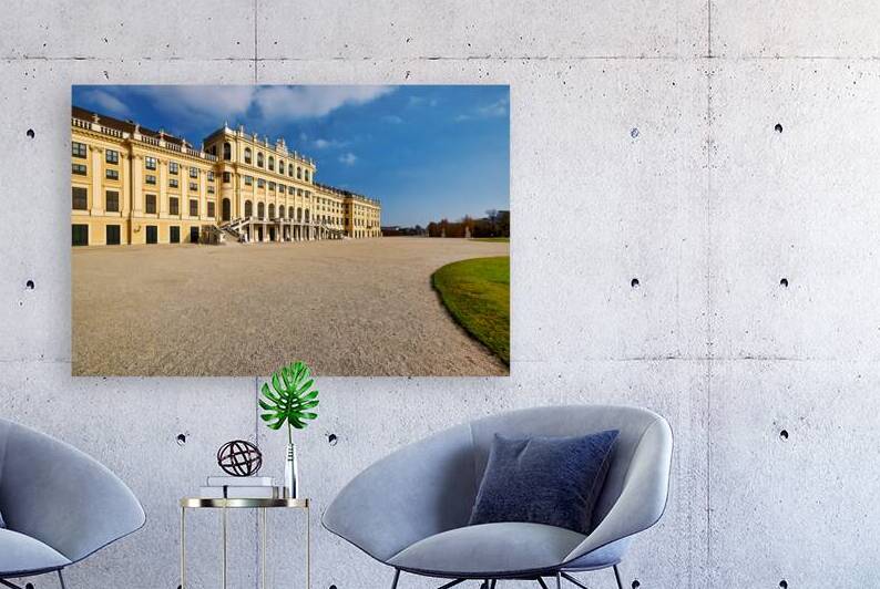 Majestic yellow palace gravel courtyard blue sky. by Marco Brivio